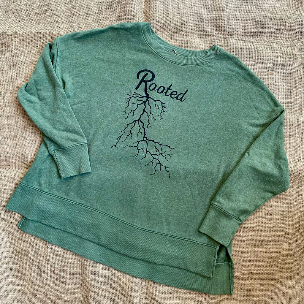 Moss green sweatshirt with Rooted print across front