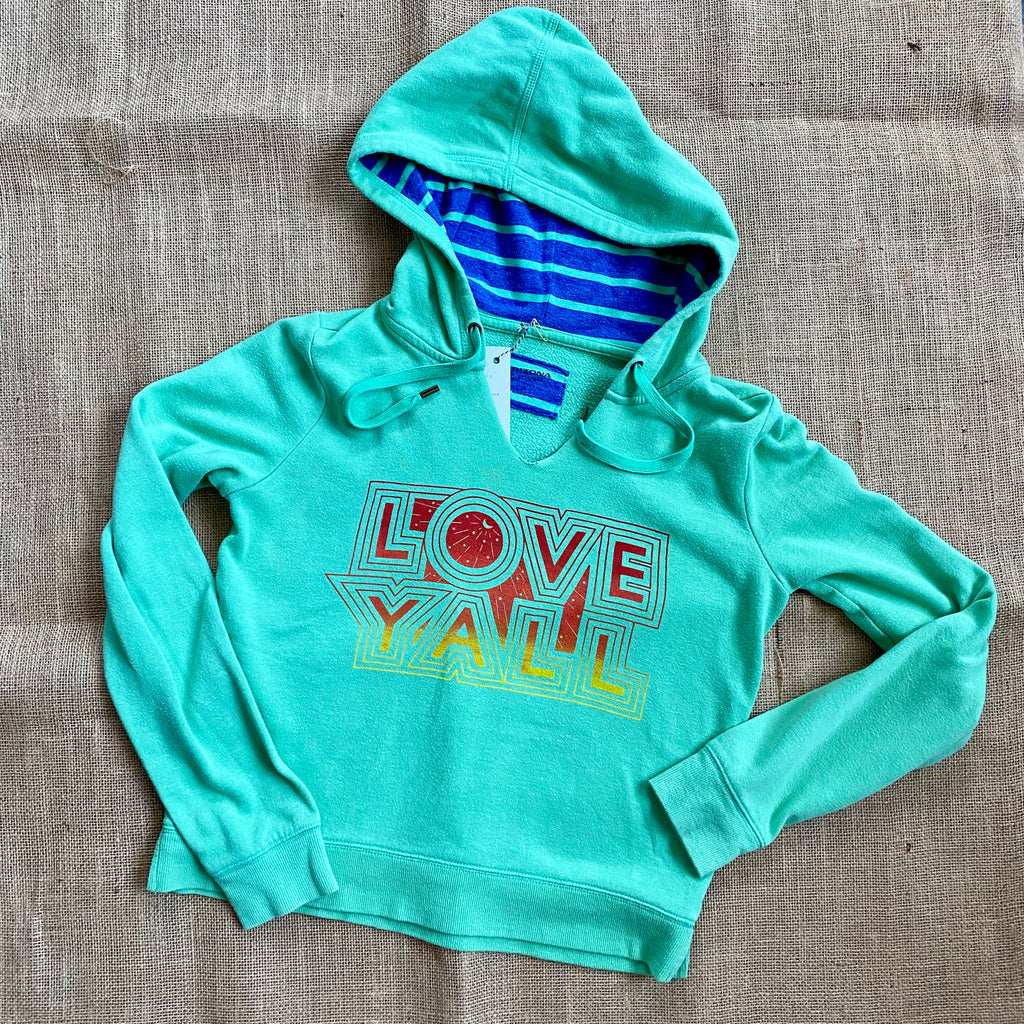 Green cropped hoodie with Love Y'all printed across the front in gradient ink