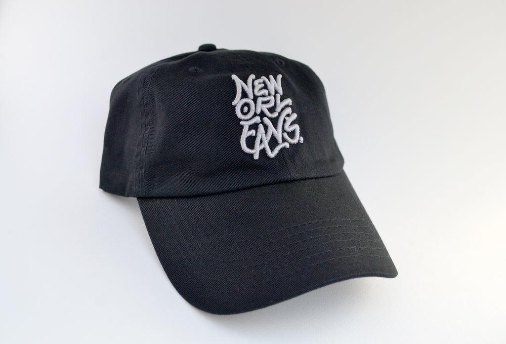 Black curved brim cap with New Orleans embroidered in grey thread.