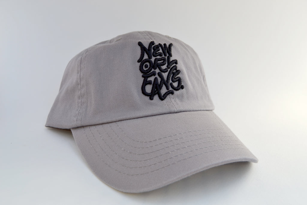 Grey curved brim cap with New Orleans embroidered in black thread.