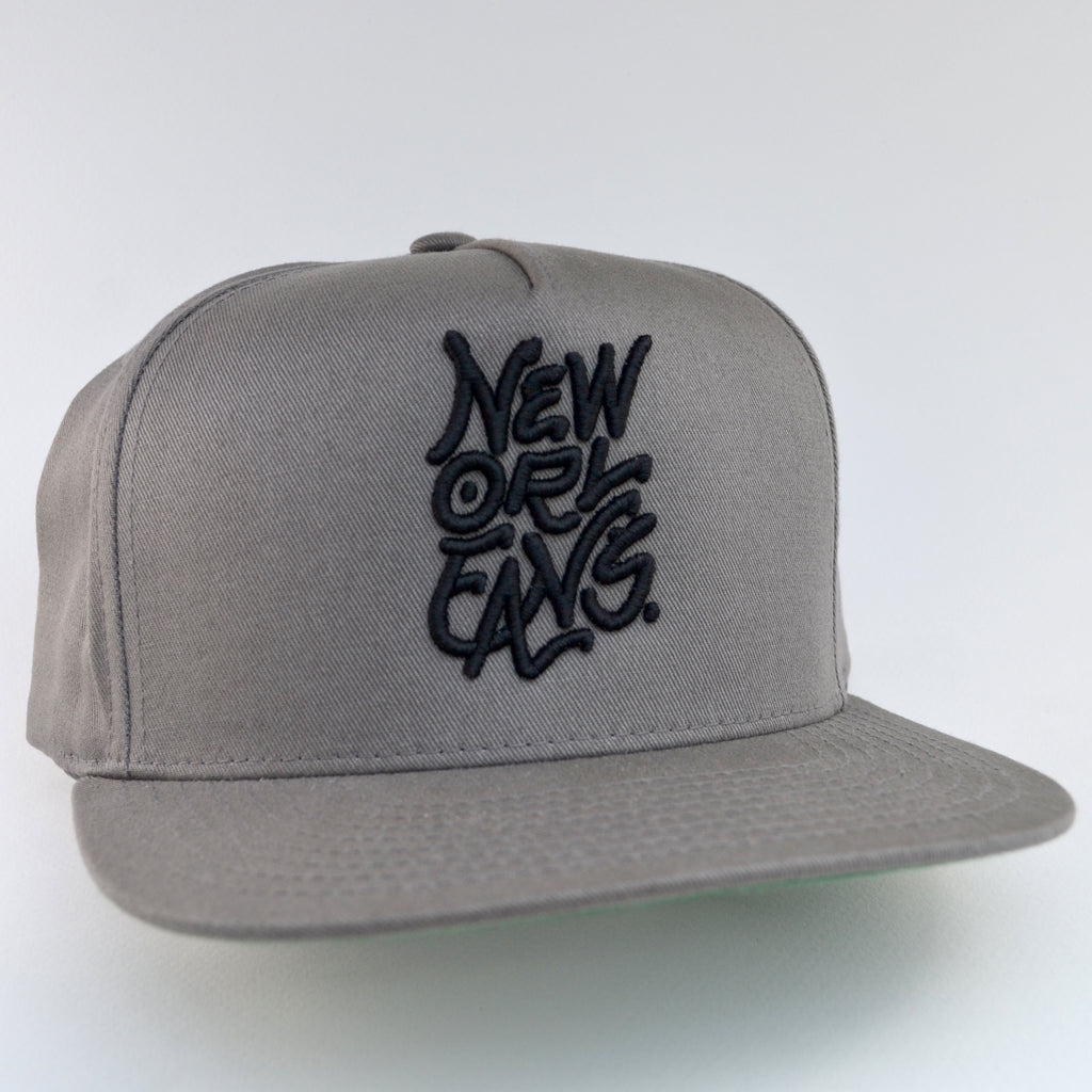 Grey flat brim cap with black embroidery of New Orleans across front